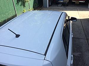 2009 xD Roof Rust under Black Vinyl Roof Strips-img_2580.jpg